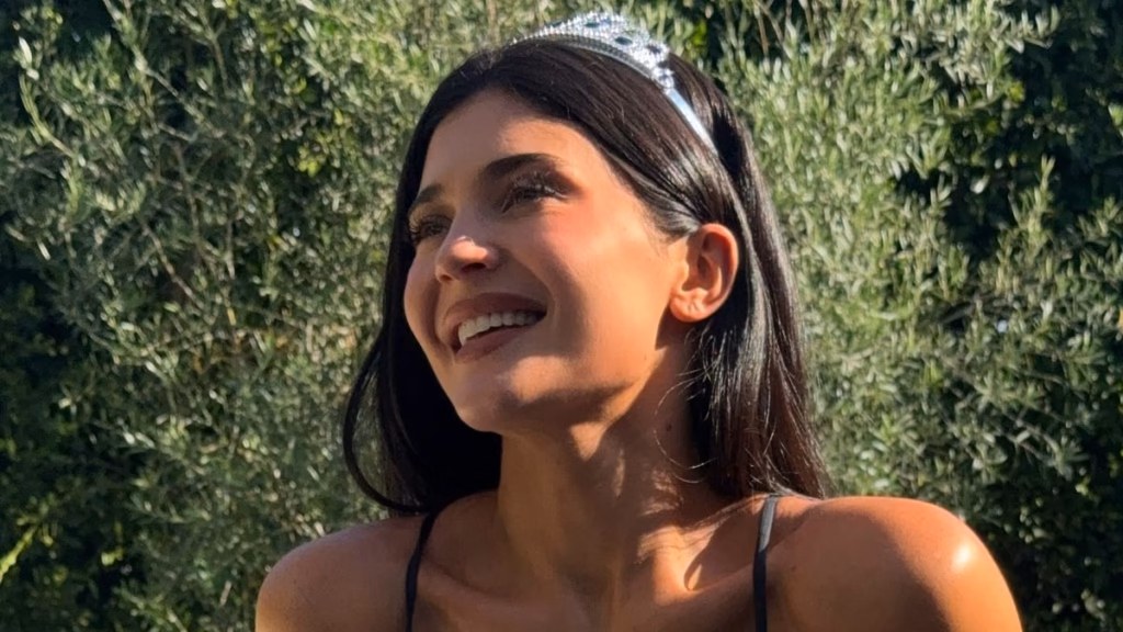 Kylie Jenner strips right down to miniature bikini and tiara after being trolled over her 'indecent' costume at pal Jordyn Woods's marriage ceremony