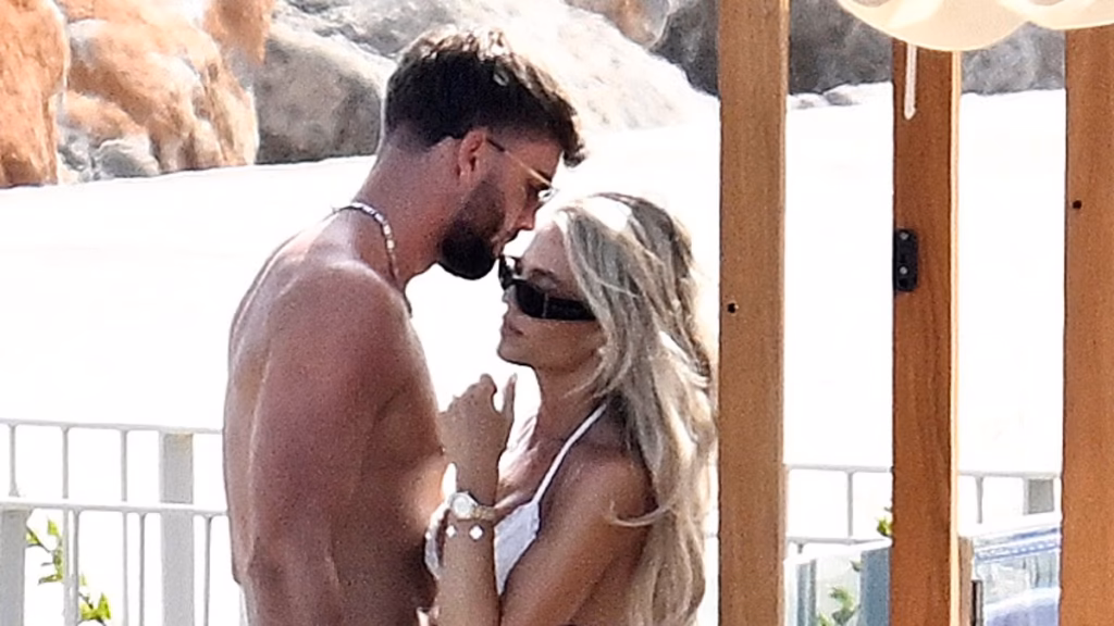Love Island's Molly Smith accepting her bridal period in a white thong bikini as she cuddles shirtless husband Tom Clare at a Mallorca seashore membership after their boozy marriage ceremony