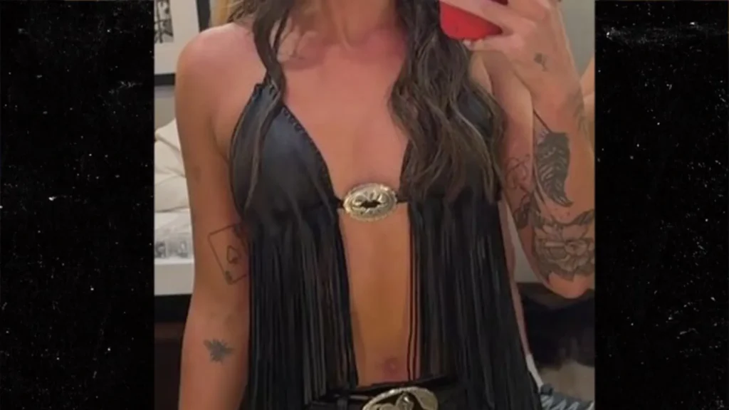 Which cowgirl is pictured in a revealing top?