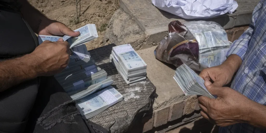 Iranian currency plunges as oil sales and payments falter