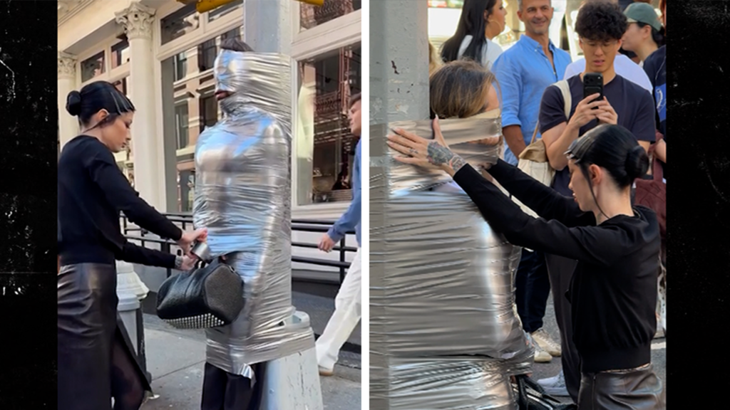 Dominatrix and Alexander Wang tape man to New York street post