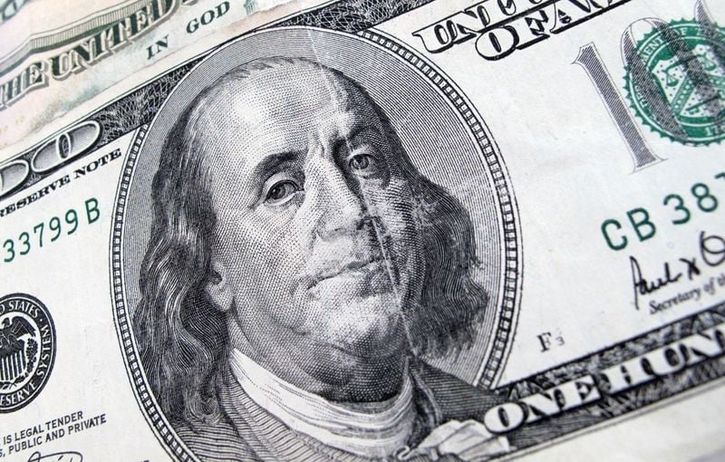 Dollar eases as yields and oil fall; Aussie gains on hawkish RBA