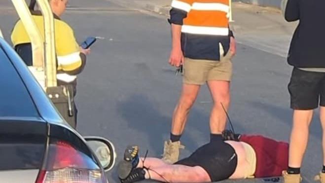 Melbourne tradies restrain masked axeman after alleged carjacking