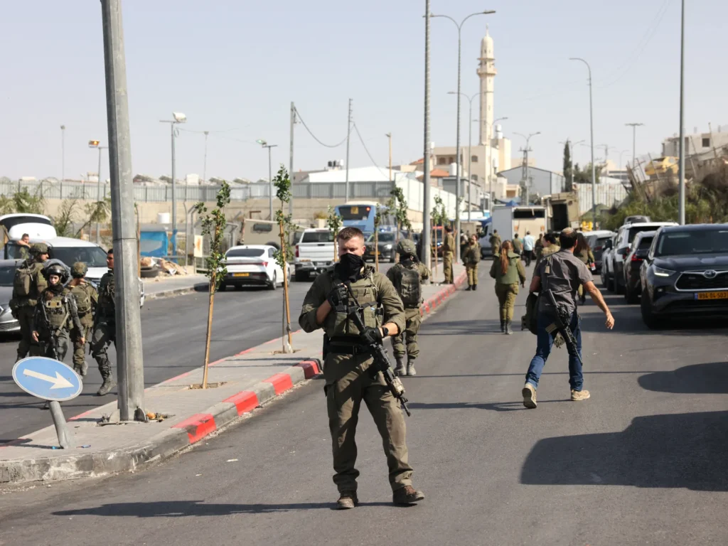 Israeli forces raid West Bank towns, detaining dozens